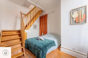 a bedroom with a bed and a staircase at Cosy flat, Duplex, proche centre ville in Lens