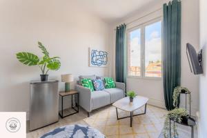 a living room with a couch and a window at Cosy flat, Duplex, proche centre ville in Lens