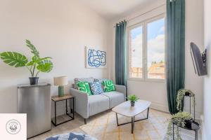 a living room with a couch and a window at Cosy flat, Duplex, proche centre ville in Lens