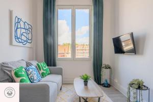 a living room with a couch and a window at Cosy flat, Duplex, proche centre ville in Lens +7 photos