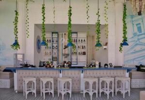 a bar with white stools and a blue counter at Arena Beach Resort & Spa in Hurghada +130 photos