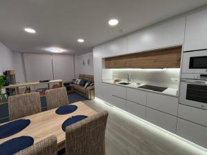 a kitchen and dining room with a table and chairs at Marea in Sanxenxo +14 photos