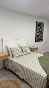 a bedroom with a large bed with two tables at Marea in Sanxenxo