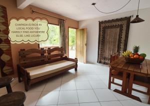 a living room with a bench and a table at Refúgio na Mata in Lençóis