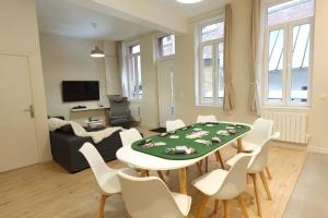 a living room with a table and white chairs at L'As d'Aubert - 8 pers - Centre in Arras