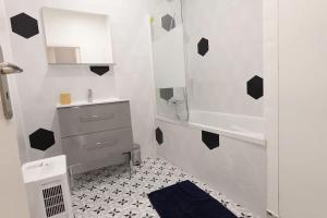 a white bathroom with a sink and a shower at L'As d'Aubert - 8 pers - Centre in Arras +21 photos