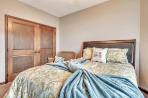 a bedroom with a bed and a wooden door at Bridges Bay Resort Brooklyn Building 308 in Arnolds Park