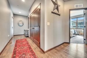 a hallway with a door and a red rug at Bridges Bay Resort Brooklyn Building 308 in Arnolds Park