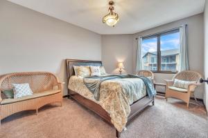 a bedroom with a bed and two chairs and a window at Bridges Bay Resort Brooklyn Building 308 in Arnolds Park