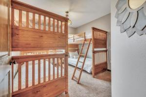 a bedroom with two bunk beds and a ladder at Bridges Bay Resort Brooklyn Building 308 in Arnolds Park +29 photos
