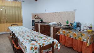 a kitchen with two tables and a sink in it at Casa vacanze San Gianni in Ardore Marina +8 photos