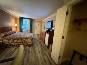 a hotel room with a bed and a television at America's Inn Houston/Stafford /Sugarland in Houston
