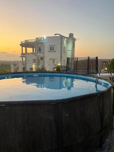 a hot tub in front of a house with the sunset at Duplex Villa 4 rooms in Marsa Matruh
