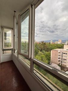an empty room with three windows with a view at La Plaza Apart in Mendoza