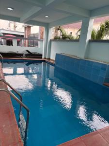 a swimming pool with blue tile in a house at Fukusu II in Ikuata