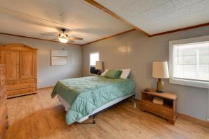 a bedroom with a bed and a ceiling fan at Lake Views + Dock Access: Georgetown Group Getaway in Georgetown