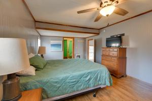 a bedroom with a bed and a dresser with a television at Lake Views + Dock Access: Georgetown Group Getaway in Georgetown