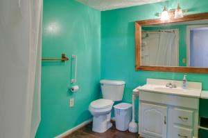 a bathroom with a toilet and a sink and a mirror at Lake Views + Dock Access: Georgetown Group Getaway in Georgetown +19 photos