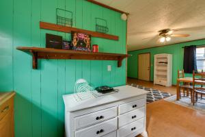 a kitchen with green walls and a white cabinet at Couple’s Retreat w/ Dock Access on Lake Eufaula! in Georgetown