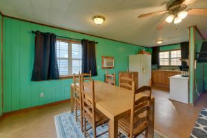a kitchen with green walls and a table and chairs at Couple’s Retreat w/ Dock Access on Lake Eufaula! in Georgetown