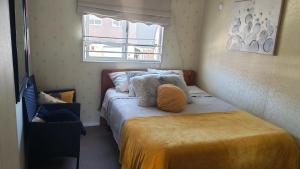 a small bedroom with a bed and a window at La casa de Belén in Valdivia