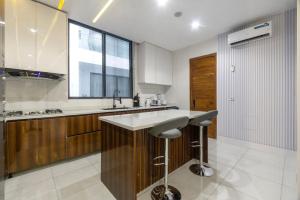 a kitchen with a counter and a sink and a window at Olaz holmes in Lagos