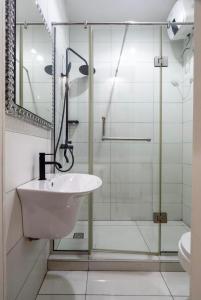 a bathroom with a glass shower and a sink at Olaz holmes in Lagos +6 photos