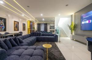 a large room with couches and a large screen at Olaz holmes in Lagos