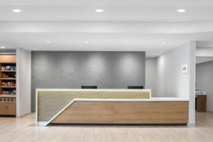 a lobby with a reception desk in a building at SpringHill Suites by Marriott Atlanta Covington in Covington +21 photos