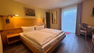 a bedroom with a large bed in a room at Hotel Restaurant Freihof in Oberharmersbach +89 photos