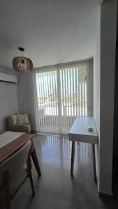 a living room with a table and a couch at Departamento BARBÚ in Villa María