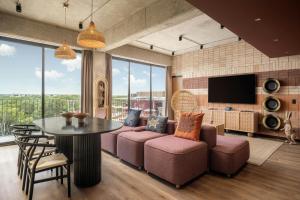 a living room with a couch and a table at Moxy Tulum in Tulum