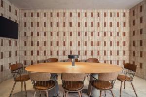a conference room with a wooden table and chairs at Moxy Tulum in Tulum +103 photos