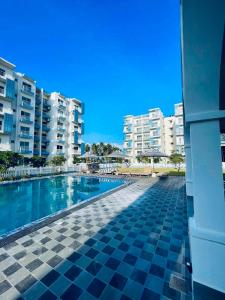 a view of the swimming pool of the apartment buildings at Santorini Transit hotel in Negombo