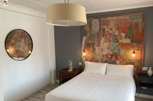 a bedroom with a white bed and a mosaic wall at Casa con embarcadero in Los Mártires