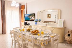 a dining room with a table and a mirror at Exclusive Large 3 bed room Apartment with Pool Central Sorrento in Sorrento
