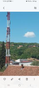 a tower on top of a roof with a building at Hostel Yugoslavija 1 in Aleksandrovac