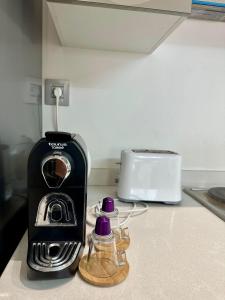 a toaster sitting on a kitchen counter next to a toaster at Le murmure in Oulad Akkou +4 photos