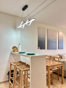 a kitchen and dining room with a table and chairs at Le murmure in Oulad Akkou