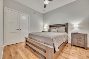 a bedroom with a bed and a dresser with two lamps at Stillwater 113 in Arnolds Park