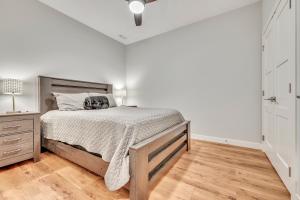 a bedroom with a bed and a wooden floor at Stillwater 113 in Arnolds Park