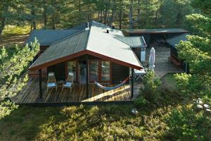 an aerial view of a log cabin with a porch at Authentic Summerhouse Near The Beach in Rørvig