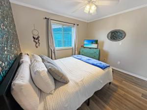 a bedroom with a bed and a window at Portabella Paradise in Carolina Beach