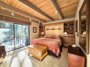 a bedroom with a bed and a large window at Cheyenne's Place home in Kings Beach