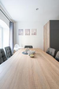 a large wooden table in a room with chairs at COY Apartments Kapfenberg - Spacious Stays for Companies, Groups & Workers in Kapfenberg