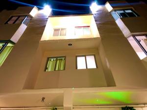 a large white building with lights on top of it at Hotel MERLI in Asunción Nochixtlán