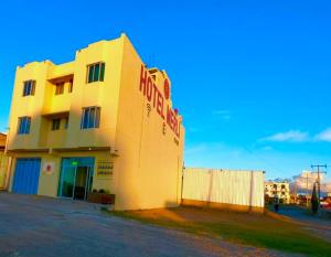 a building with a sign on the side of it at Hotel MERLI in Asunción Nochixtlán