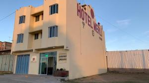 a building with a sign on the side of it at Hotel MERLI in Asunción Nochixtlán