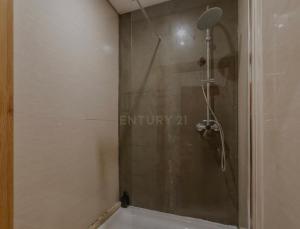 a shower with a glass door in a bathroom at Portela Room in Carnaxide +6 photos