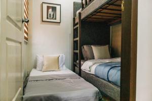 two bunk beds in a room with twounks at Rubi's House in Ilayang Talim